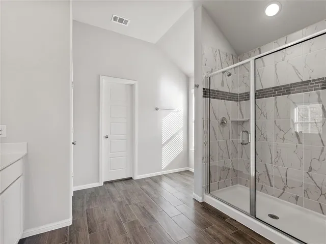 a bathroom with a glass shower door