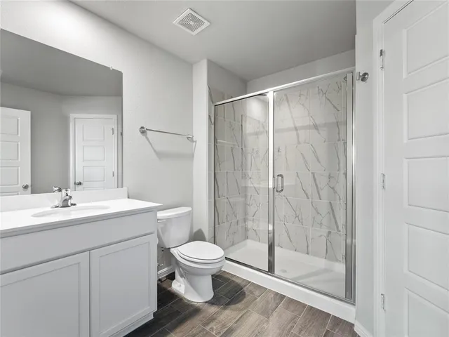 a bathroom with a toilet sink and shower