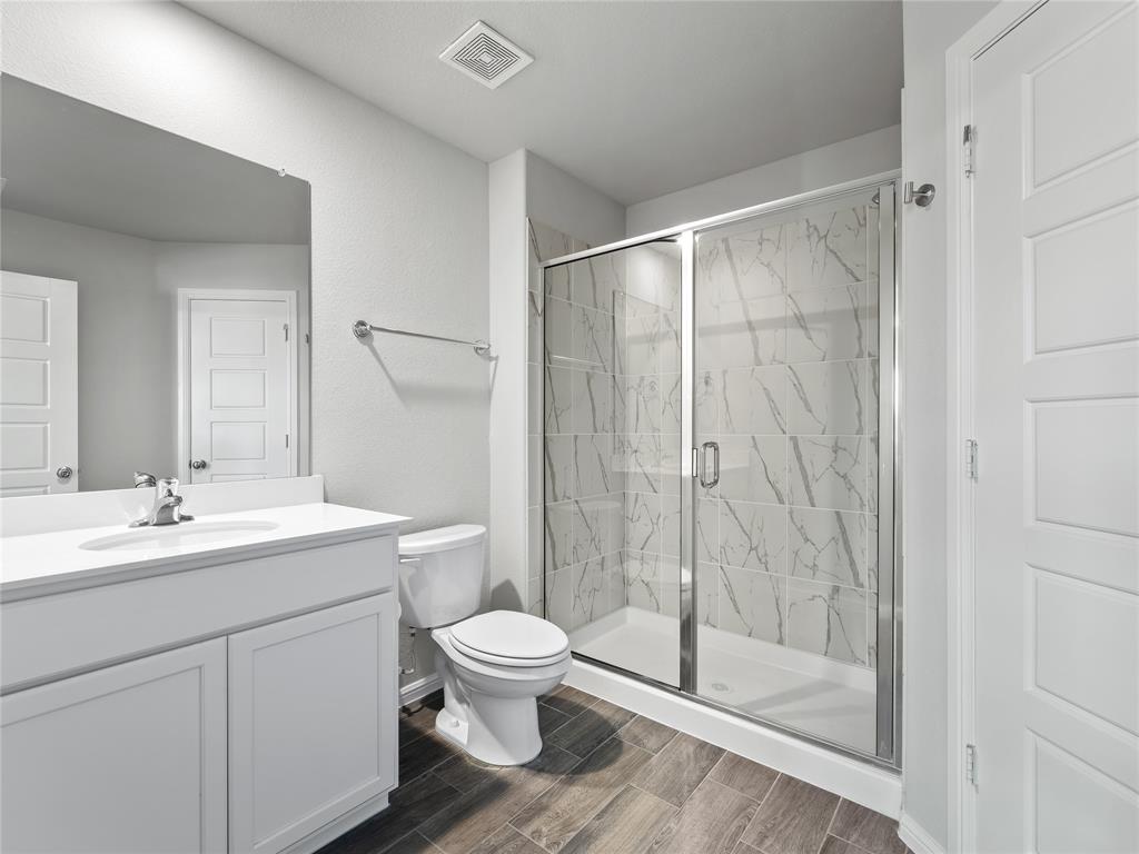 3301 Redbud Flower Trail Venus, TX 76084 - Photo 19 of 28 a bathroom with a toilet sink and shower