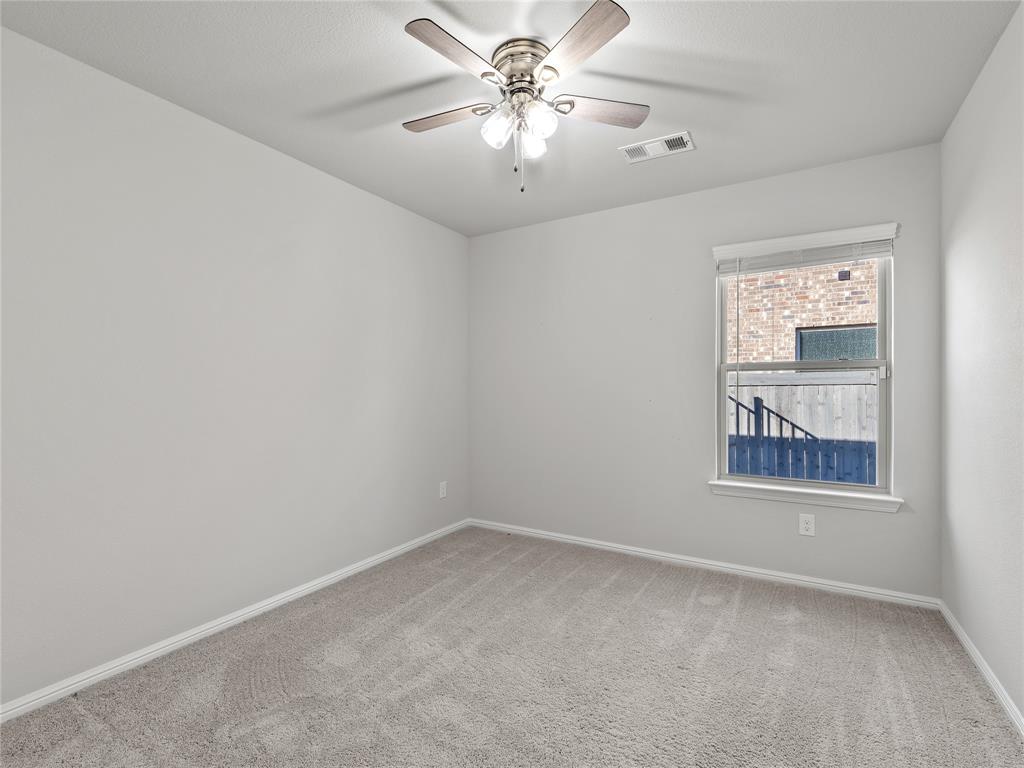 3301 Redbud Flower Trail Venus, TX 76084 - Photo 21 of 28 an empty room with windows and fan