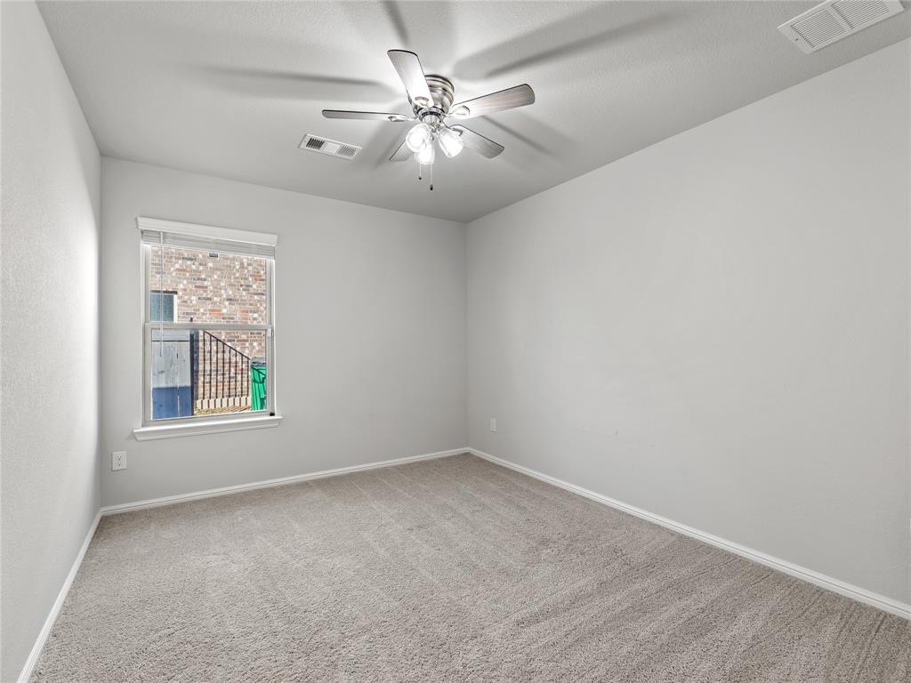 3301 Redbud Flower Trail Venus, TX 76084 - Photo 22 of 28 an empty room with windows and chandelier fan