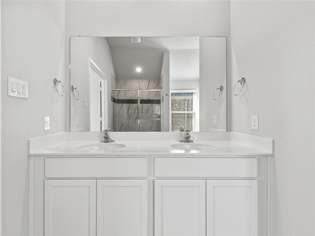 3301 Redbud Flower Trail Venus, TX 76084 - Photo 23 of 28 a bathroom with a sink and a mirror