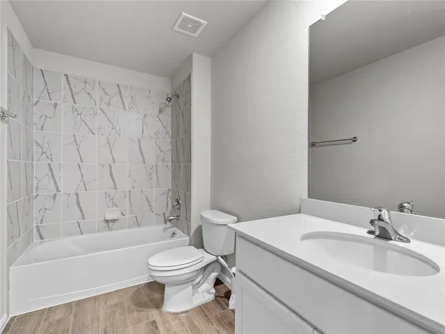 a bathroom with a toilet a sink and a bathtub