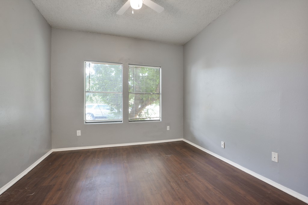 9506 Kempler Drive, Unit A Austin, TX 78748 - Photo 13 of 14 an empty room with wooden floor and windows