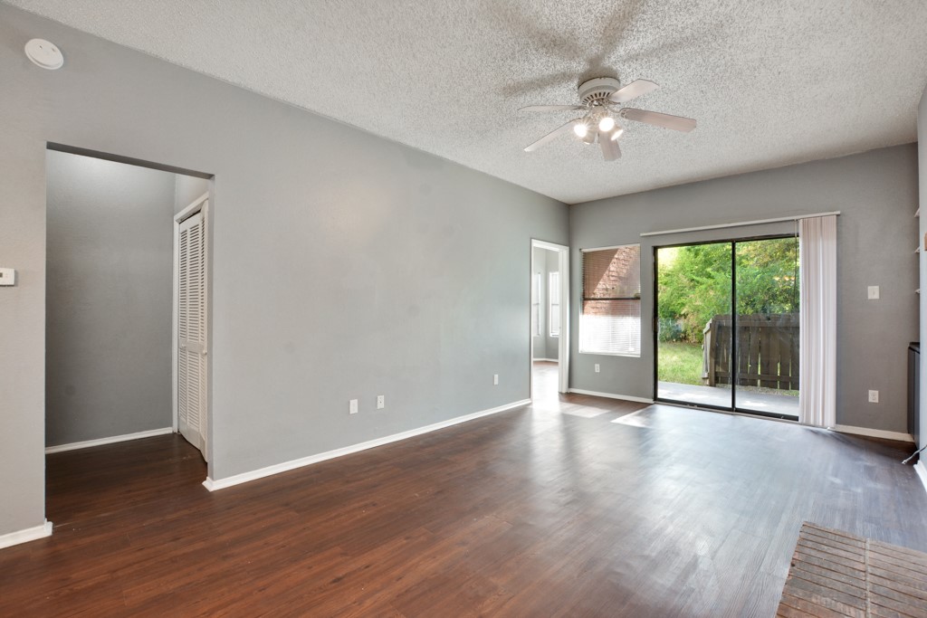 9506 Kempler Drive, Unit A Austin, TX 78748 - Photo 3 of 14 a view of an empty room with wooden floor and a window