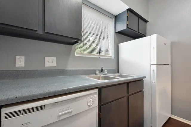 a kitchen with a sink and a refrigerator