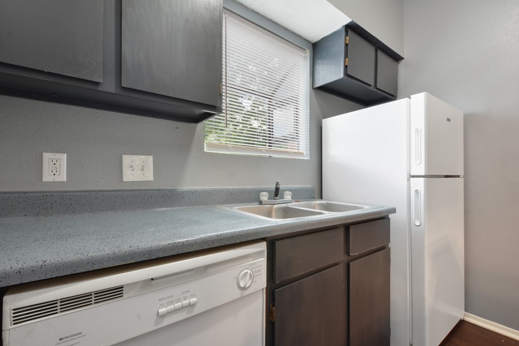 9506 Kempler Drive, Unit A Austin, TX 78748 - Photo 8 of 14 a kitchen with a sink and a refrigerator