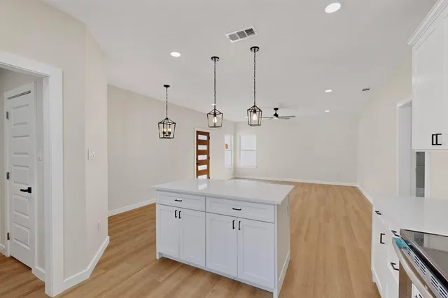a view of a kitchen with sink and wooden floor