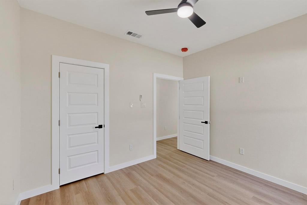 208 Rusk Street Rice, TX 75155 - Photo 21 of 27 an empty room with wooden floor closet and ceiling fan
