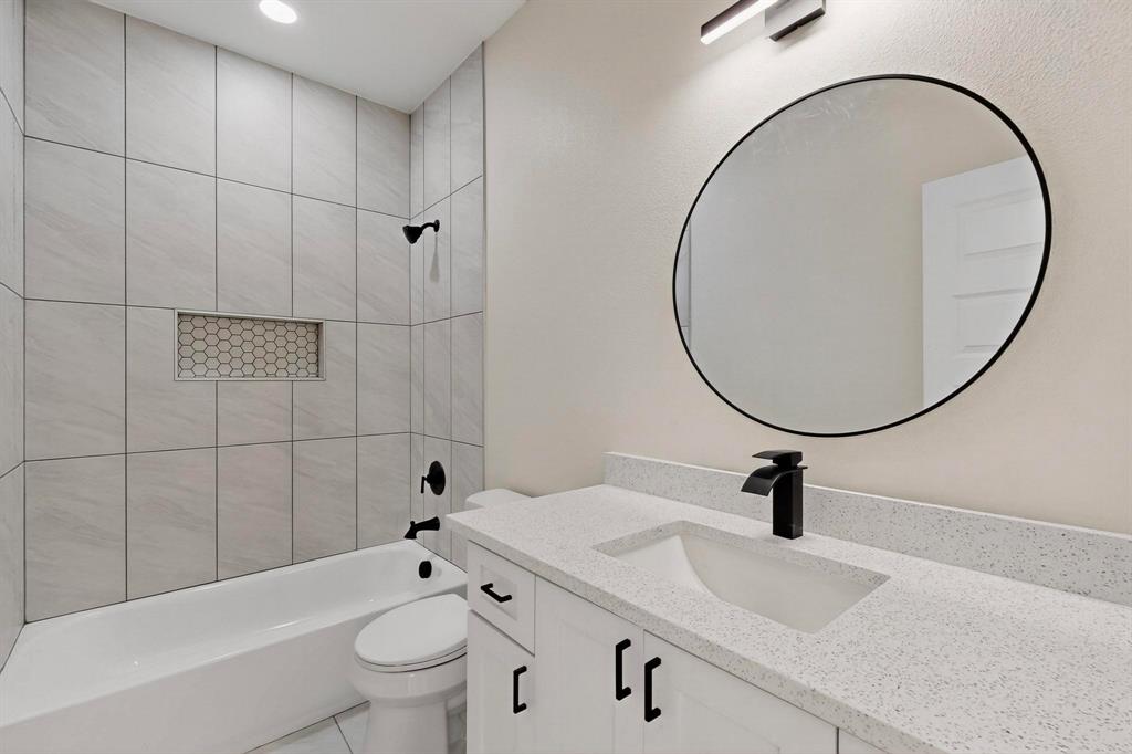 208 Rusk Street Rice, TX 75155 - Photo 22 of 27 a bathroom with a sink a toilet and a mirror