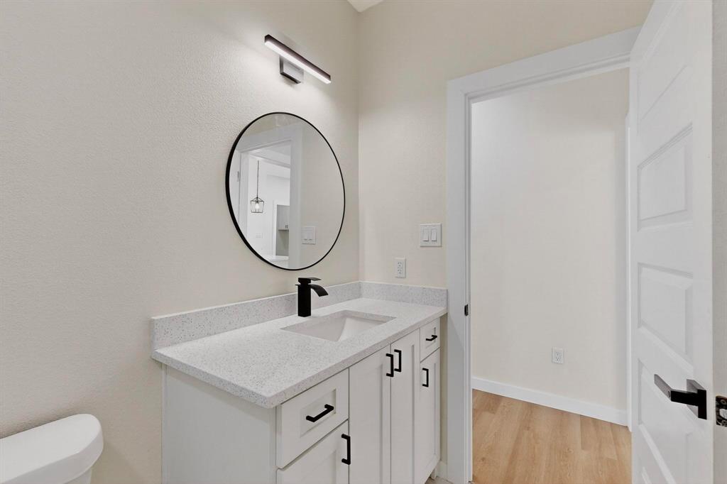 208 Rusk Street Rice, TX 75155 - Photo 23 of 27 a bathroom with a sink and a mirror