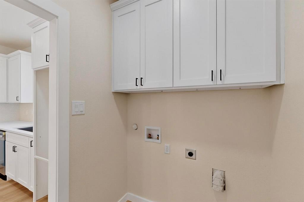 208 Rusk Street Rice, TX 75155 - Photo 24 of 27 a view of cabinets and utility room with closet