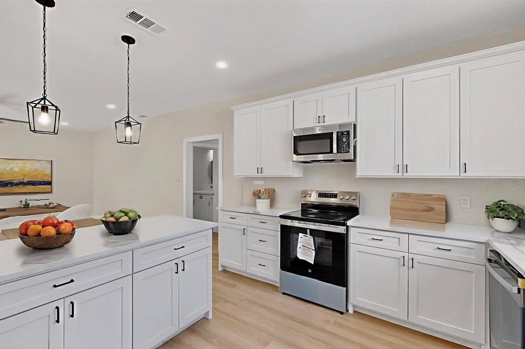 208 Rusk Street Rice, TX 75155 - Photo 3 of 27 a kitchen with cabinets appliances and a counter top space