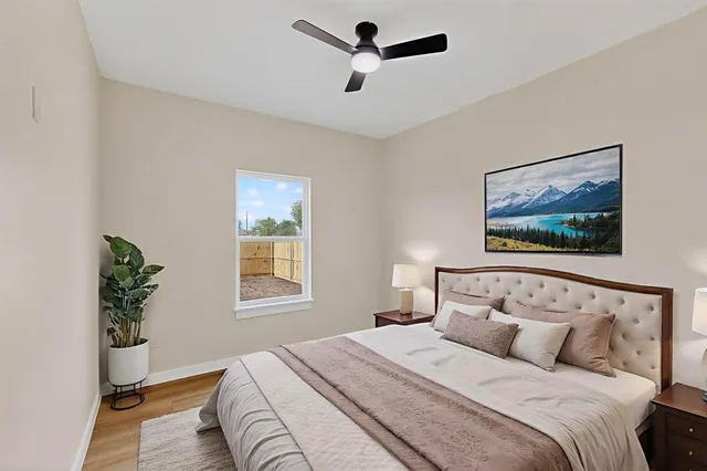 a bedroom with a large bed and a window