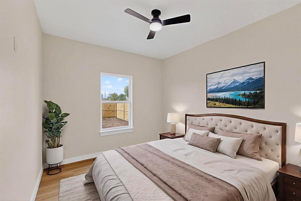 208 Rusk Street Rice, TX 75155 - Photo 5 of 27 a bedroom with a large bed and a window