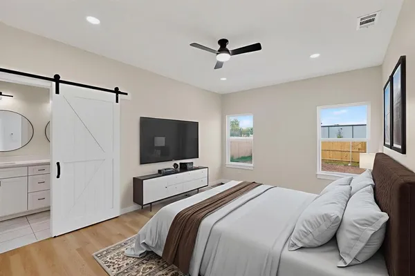 a bedroom with a bed and a flat screen tv