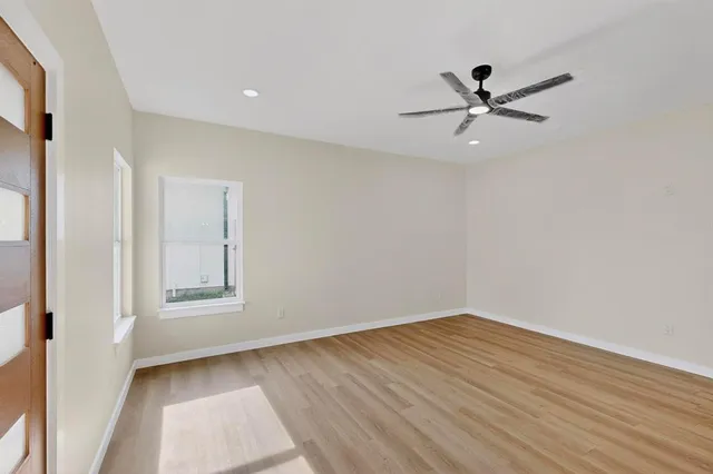 a view of a big room with wooden floor closet and windows