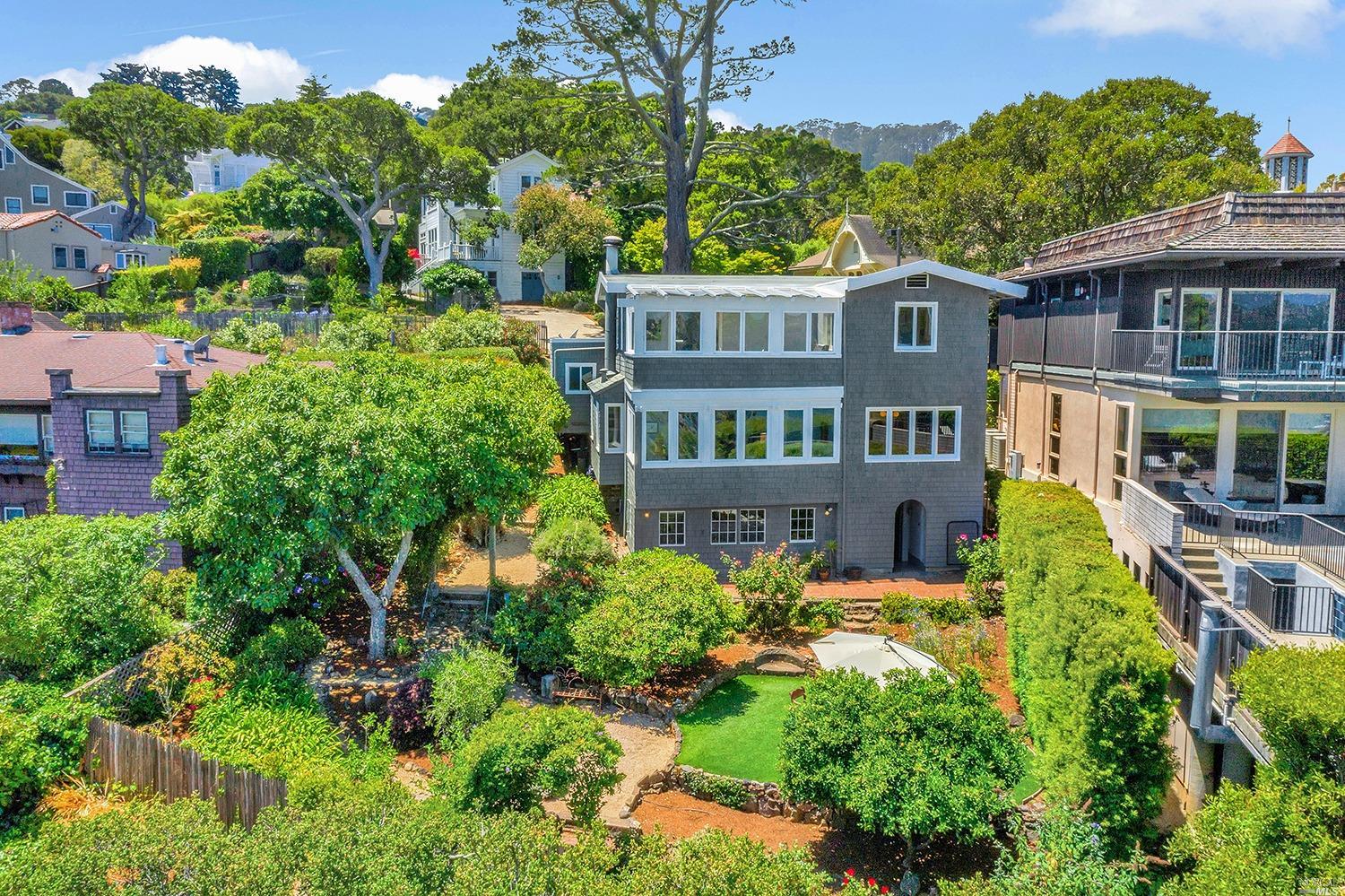 an aerial view of a house with swimming pool and garden