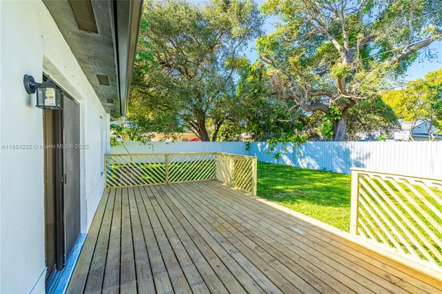 a view of outdoor space with deck and trees