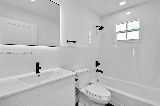 a bathroom with a sink a toilet and a bathtub