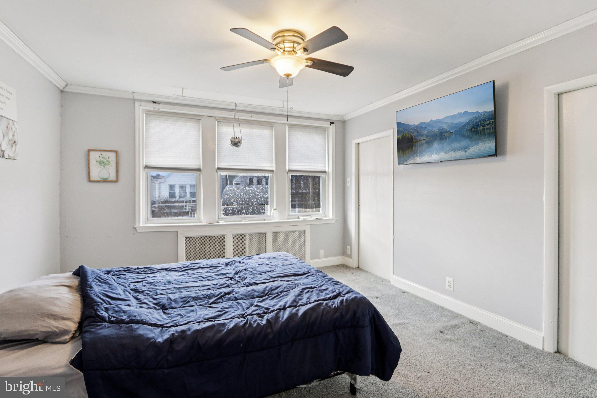 133 High Street Sharon Hill, PA 19079 - Photo 27 of 45 a bedroom with a bed and a chandelier