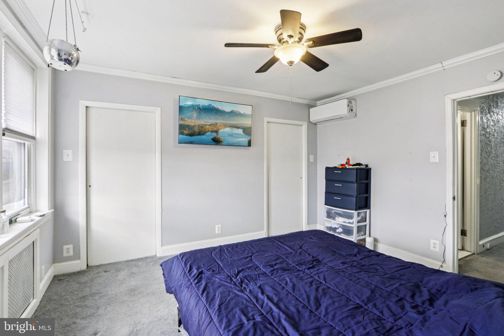 133 High Street Sharon Hill, PA 19079 - Photo 30 of 45 a bedroom with a bed a chandelier and a closet
