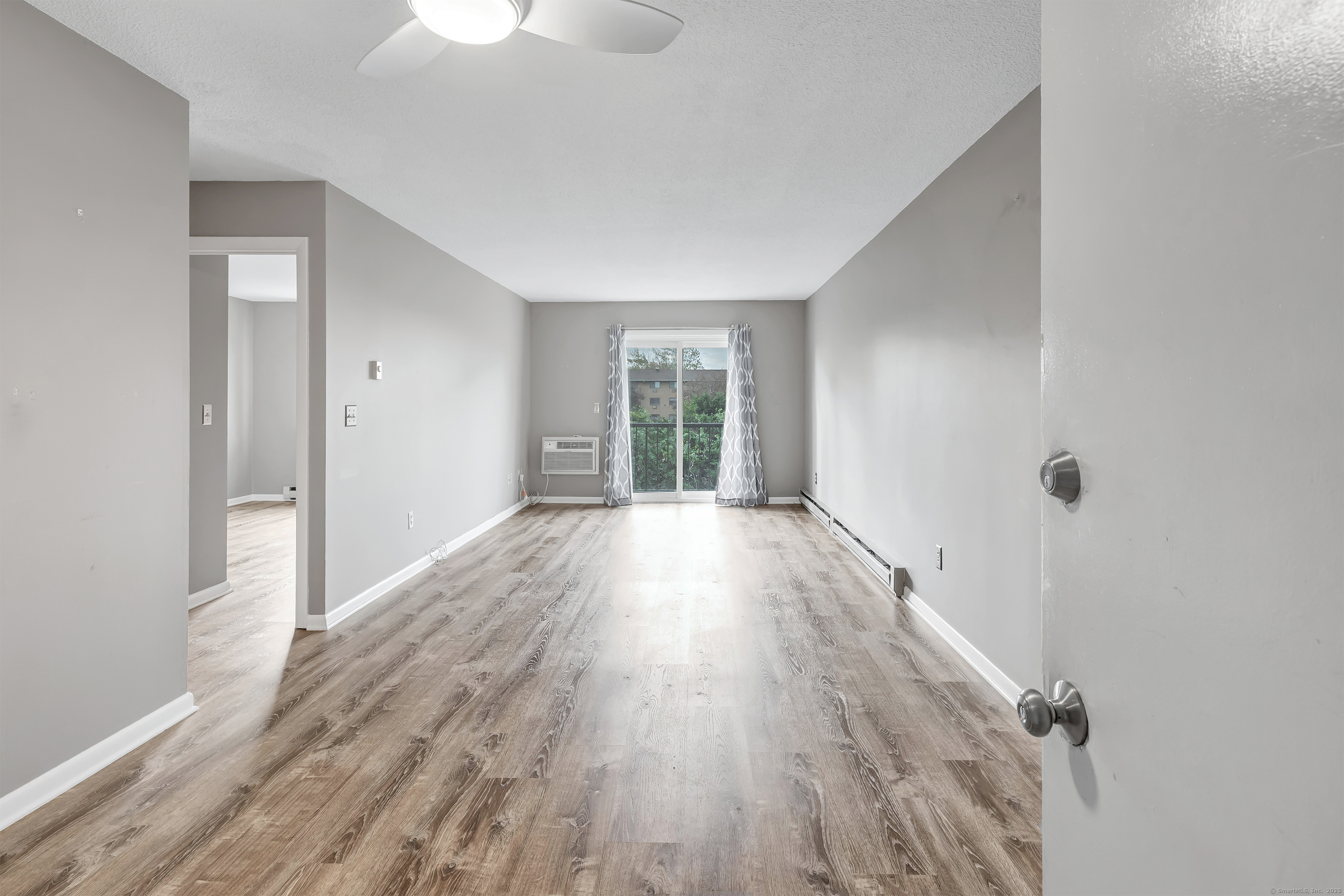 155 Short Beach Road, Unit 209 Stratford, CT 06615 - Photo 2 of 22 wooden floor in an empty room with a window