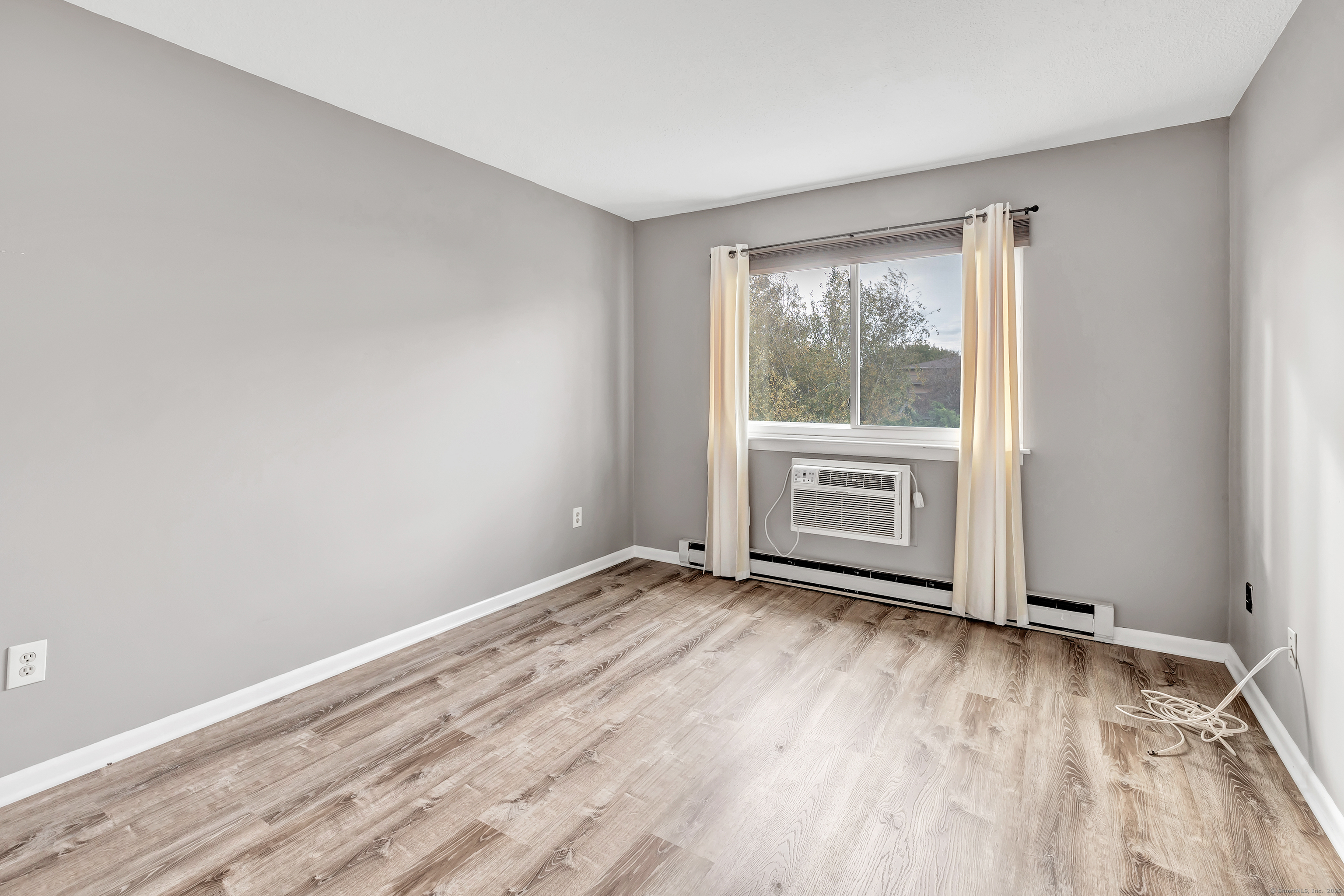 155 Short Beach Road, Unit 209 Stratford, CT 06615 - Photo 21 of 22 a view of empty room with wooden floor and fan