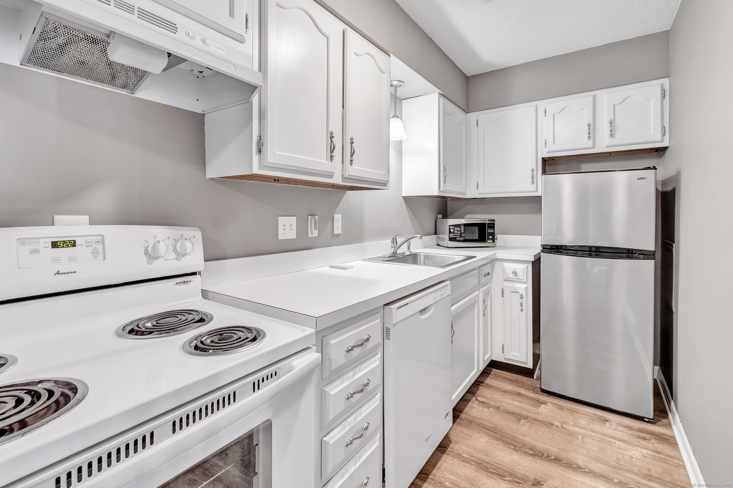 155 Short Beach Road, Unit 209 Stratford, CT 06615 - Photo 7 of 22 a kitchen with appliances a stove a sink and cabinets