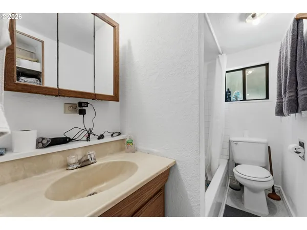 a bathroom with a sink a toilet and mirror