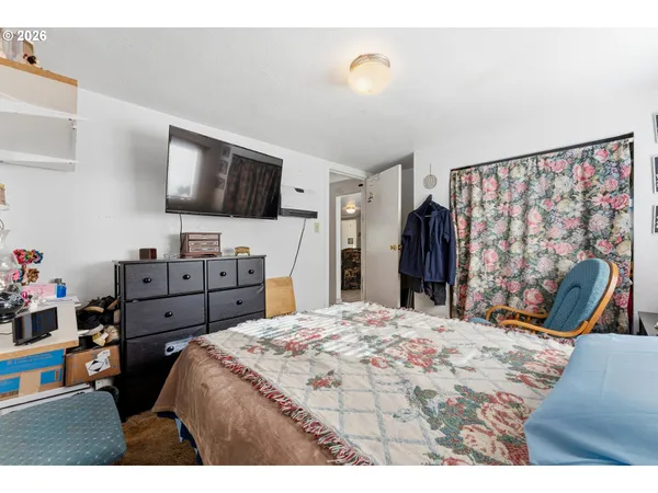 a bed room with a bed and a television