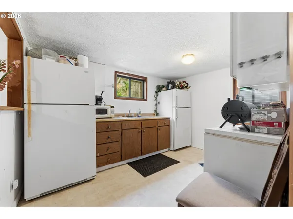 a kitchen with a refrigerator sink stove and cabinets