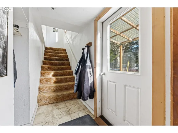 a view of entryway and hall with wooden floor