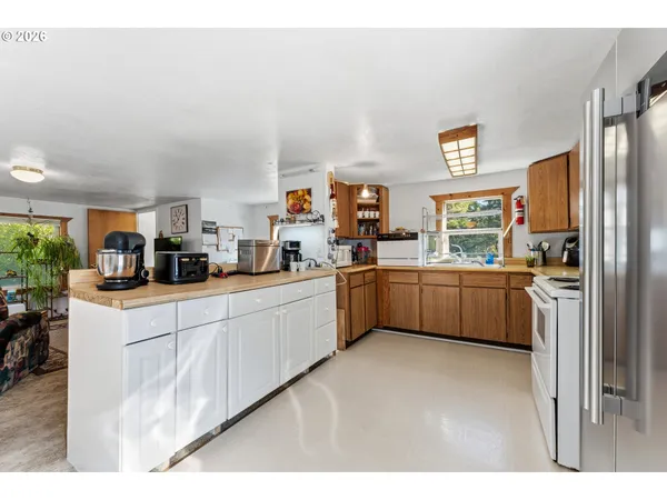 a kitchen with cabinets a sink and a stove