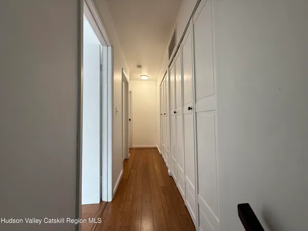 a view of a hallway with a wooden floor