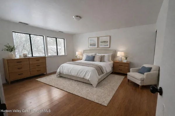 a spacious bedroom with a bed and a couch