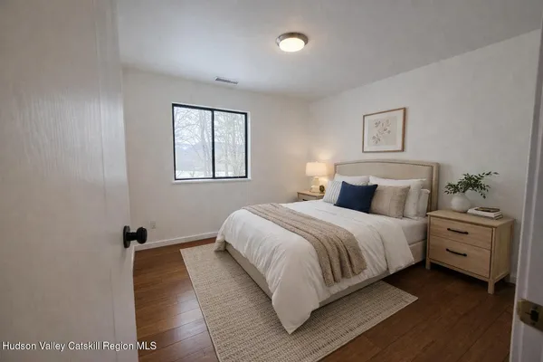 a bedroom with a bed and a night stand