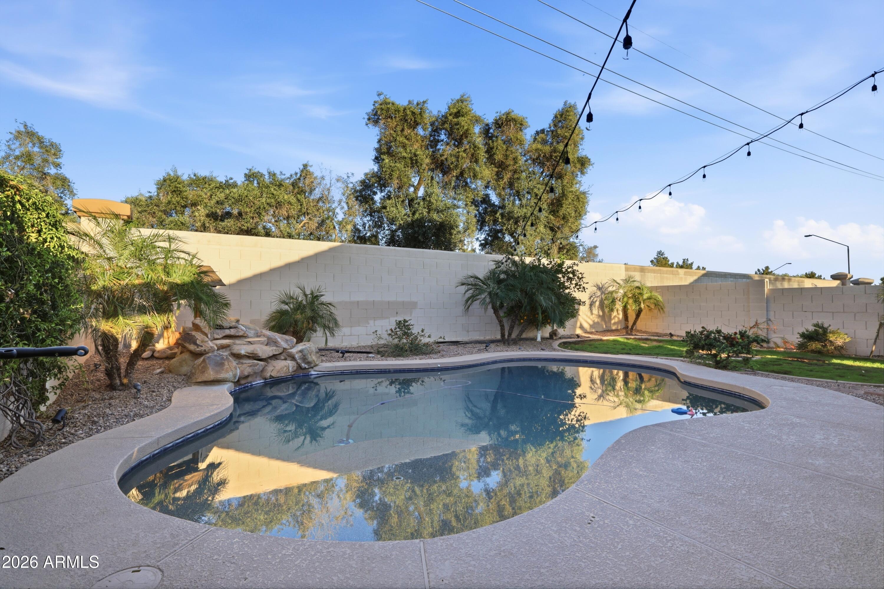661 North Joshua Tree Lane Gilbert, AZ 85234 - Photo 28 of 47 a view of a swimming pool with a yard