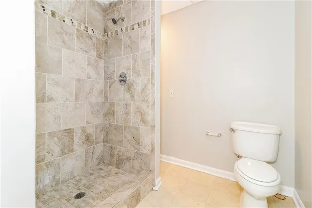 a a bathroom with a toilet and a shower