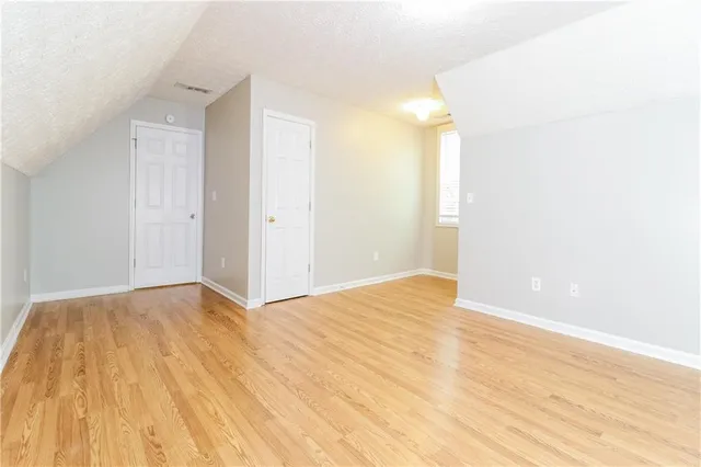 a view of an empty room and wooden floor