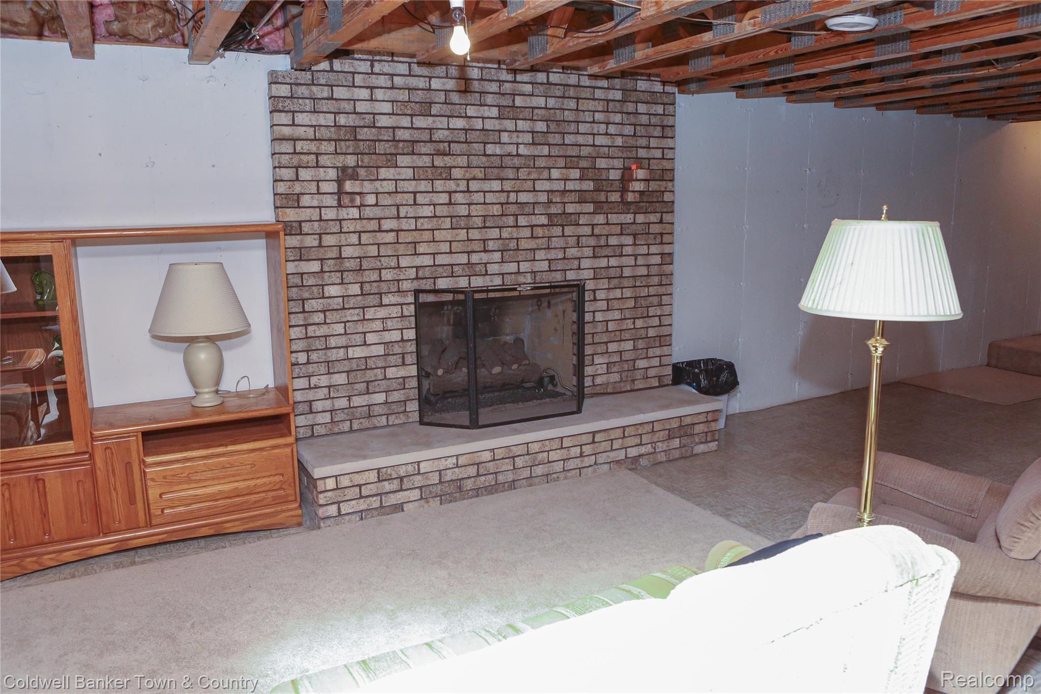 3064 West Coon Lake Road Howell, MI 48843 - Photo 35 of 47 Basement Fireplace