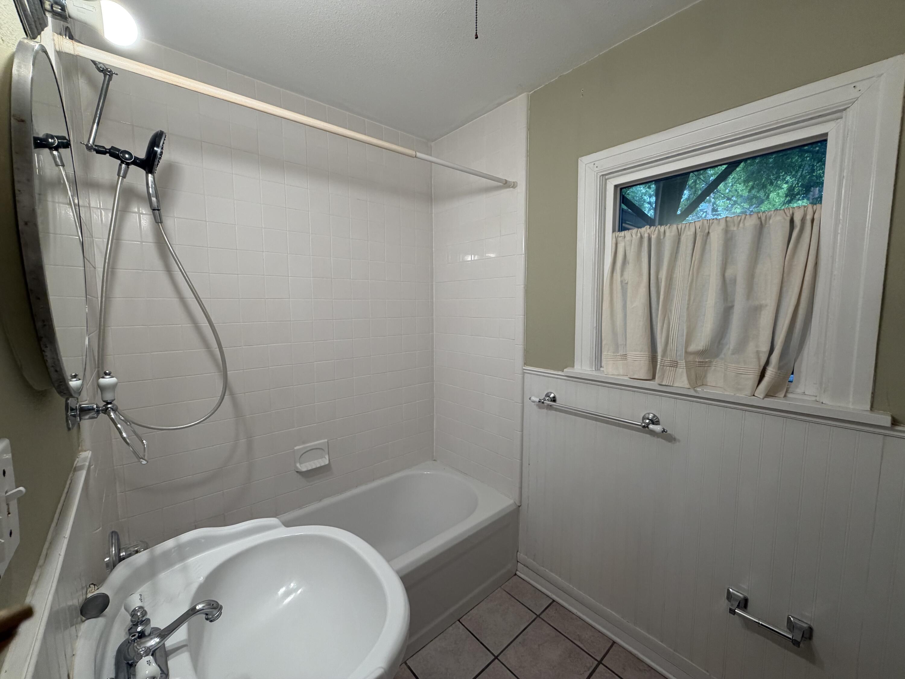 3110 22nd Street Lubbock, TX 79410 - Photo 16 of 22 a bathroom with a sink a toilet and shower