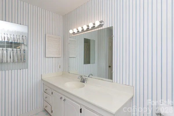 a bathroom with a white tub and shower curtain