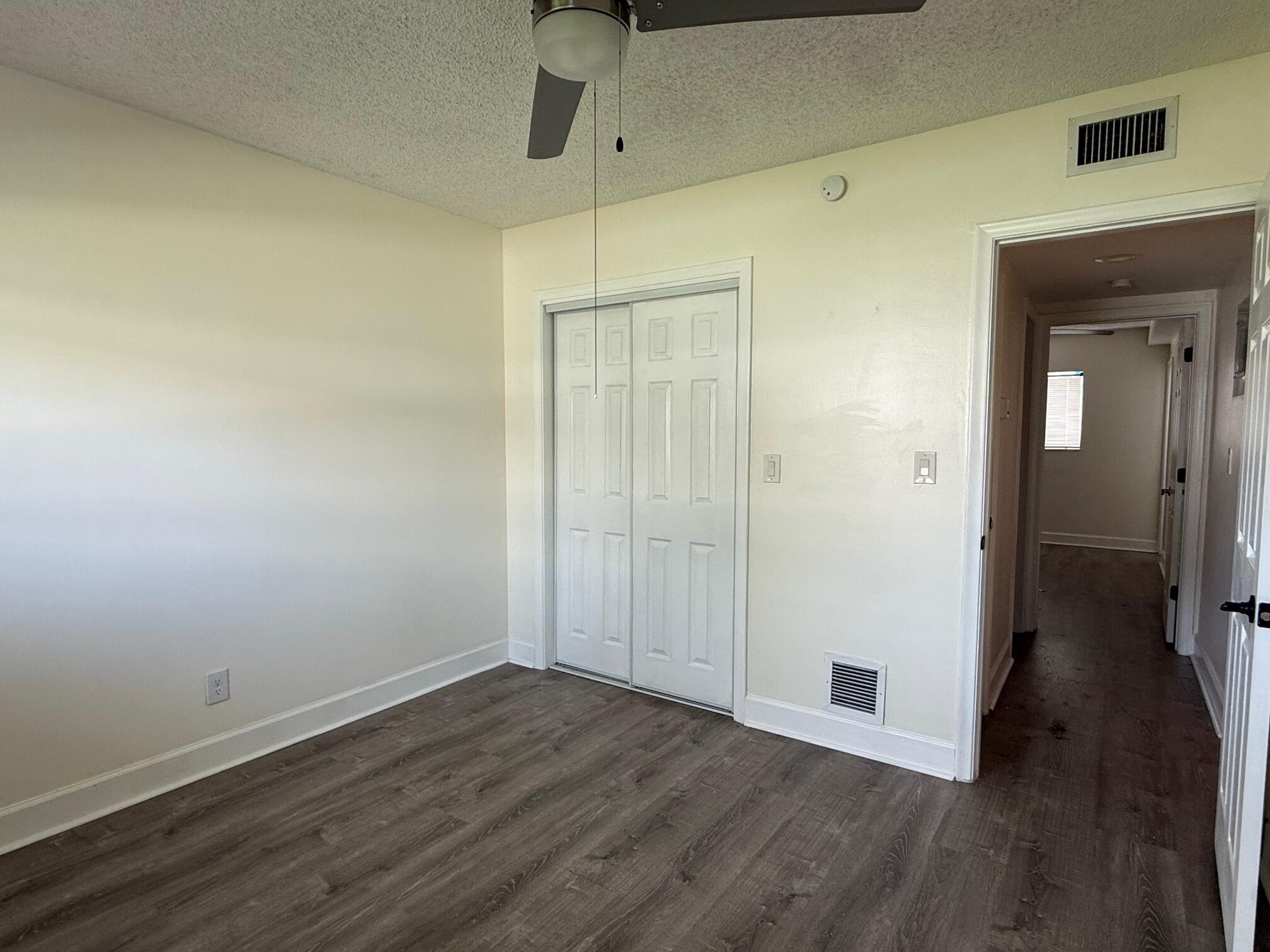 3850 Northeast 21st Way, Unit 53 Lighthouse Point, FL 33064 - Photo 11 of 18 a view of a hallway with wooden floor