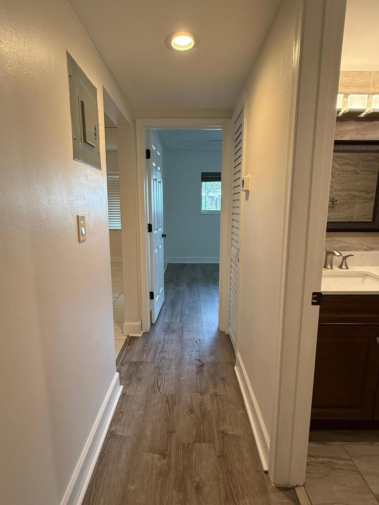 3850 Northeast 21st Way, Unit 53 Lighthouse Point, FL 33064 - Photo 12 of 18 a view of hallway with wooden floor