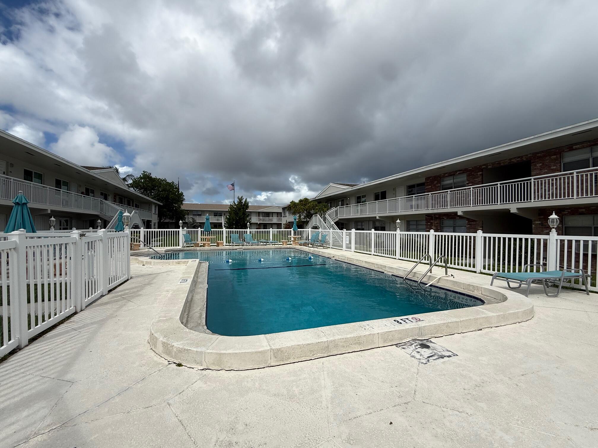 3850 Northeast 21st Way, Unit 53 Lighthouse Point, FL 33064 - Photo 18 of 18 a view of a swimming pool with a porch
