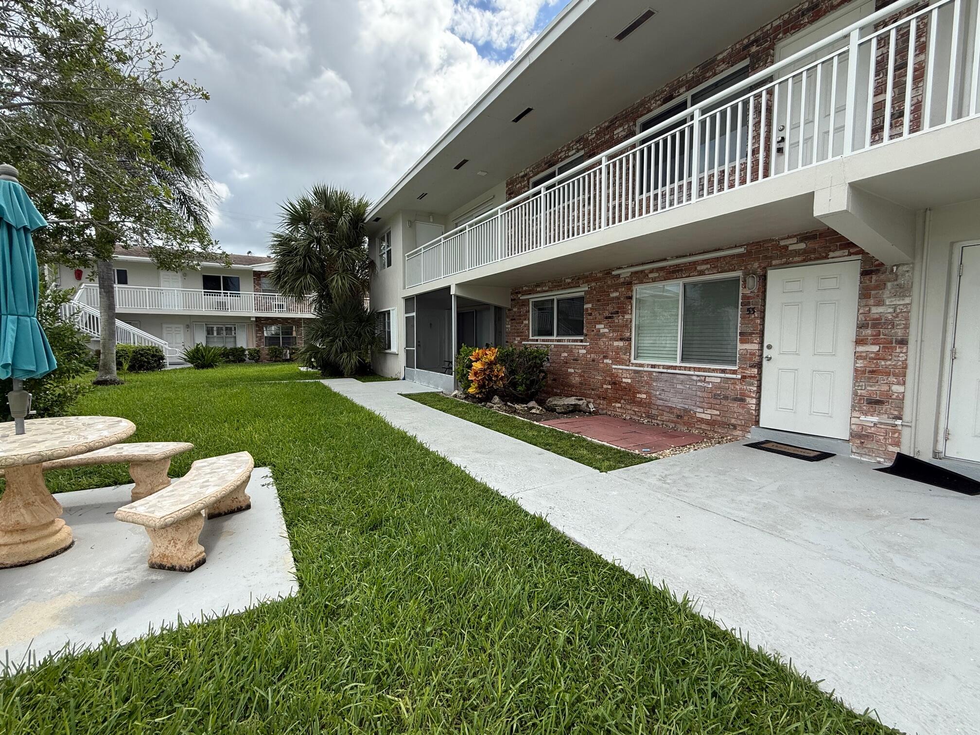 3850 Northeast 21st Way, Unit 53 Lighthouse Point, FL 33064 - Photo 2 of 18 a view of a house with a yard porch and sitting area