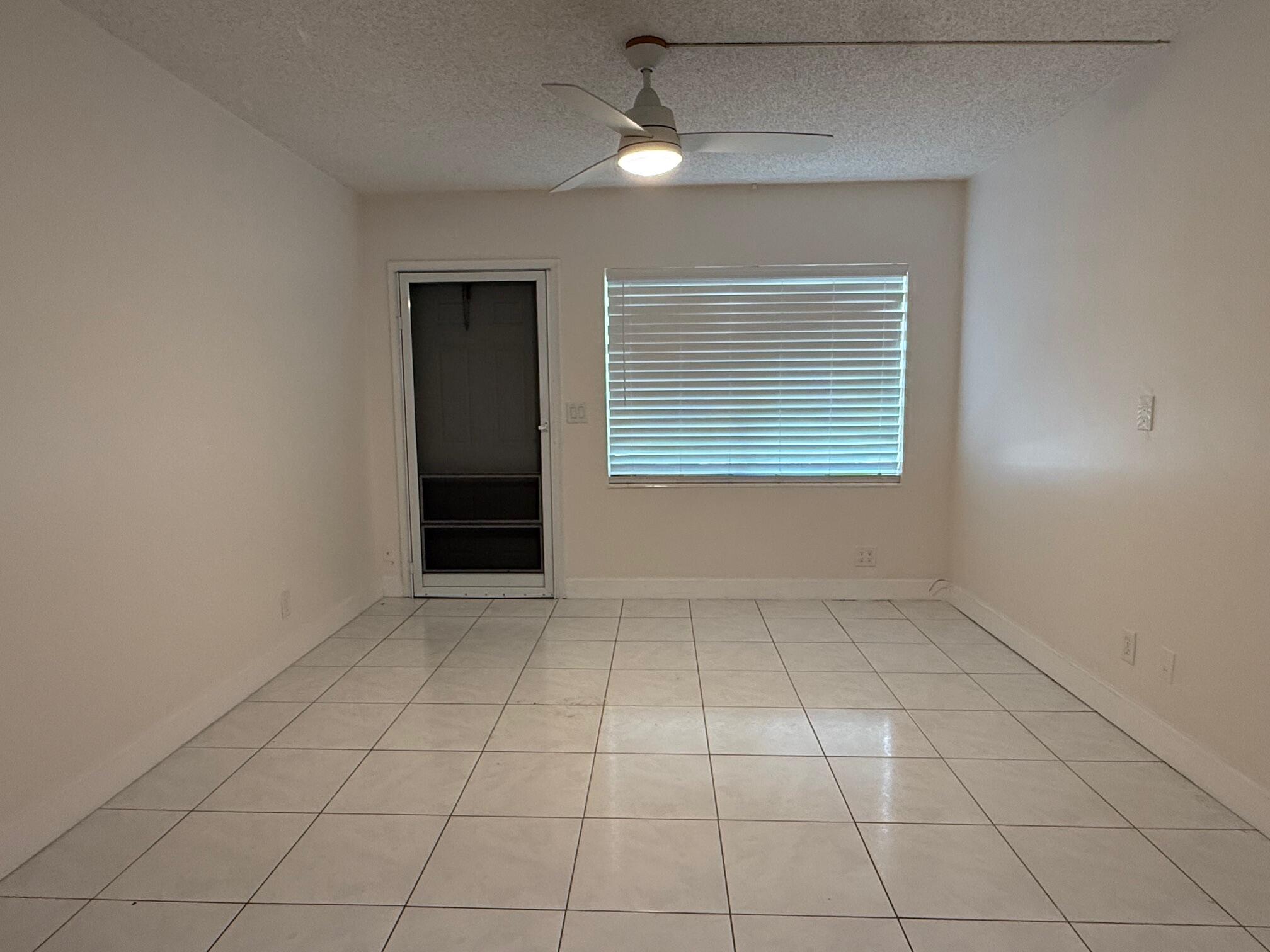 3850 Northeast 21st Way, Unit 53 Lighthouse Point, FL 33064 - Photo 7 of 18 a view of an empty room with a window