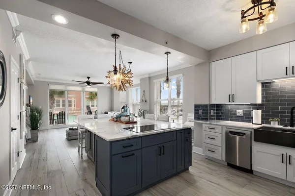 a large kitchen with a counter space a sink stainless steel appliances and cabinets