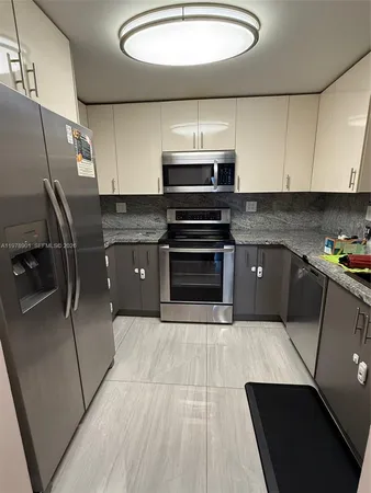 a kitchen with stainless steel appliances a stove a refrigerator and a sink